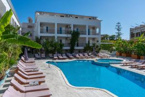 a hotel with a swimming pool and lounge chairs at Mojo Hotel Laganas Zante in Laganas