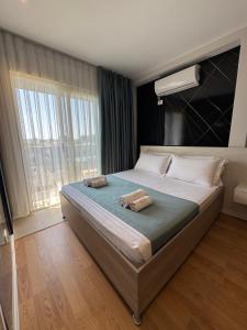 a bedroom with a large bed with a large window at Hotel Qetesia-Te Indriti in Velipojë +82 photos
