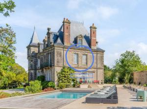 a house with a swimming pool in front of it at Le Château des Tourelles en Vendée in La Gaubretière
