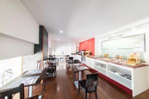 a restaurant with tables and chairs and a counter at Soho Boutique Salamanca in Salamanca