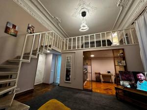 a living room with a spiral staircase in a house at LevelUp ApartHotel in Baku