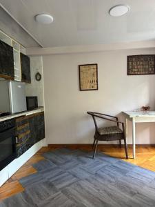 a kitchen with a chair and a table in a room at LevelUp ApartHotel in Baku +9 photos