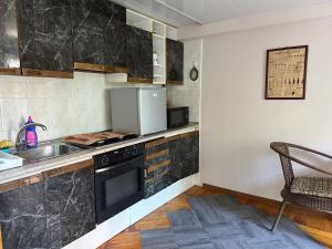 a kitchen with a sink and a stove at LevelUp ApartHotel in Baku