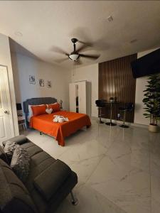 a living room with a bed and a ceiling fan at Romantic Suite in Tampa