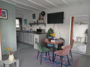 a kitchen with a table and chairs in a room at Cocos Island in Bettyʼs Bay