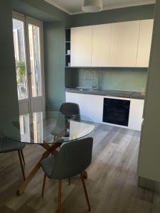 a kitchen with a glass table and some chairs at Ca Sunder in Sondrio