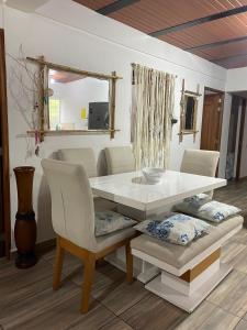 a dining room table and chairs with a white table and a mirror at Casa compartida - Las 5 Quintas in San Rafael