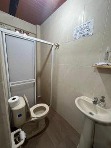 a bathroom with a toilet and a sink at Casa compartida - Las 5 Quintas in San Rafael +9 photos