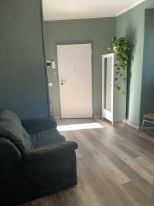 a living room with a couch in front of a door at Ca Sunder in Sondrio