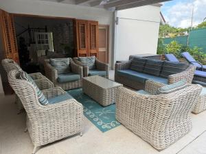 a group of wicker chairs and tables on a patio at Jacks Place - by ZenBreak in Saint Peter