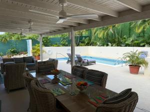 a patio with a table and chairs and a pool at Jacks Place - by ZenBreak in Saint Peter