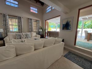 a living room with a white couch and windows at Jacks Place - by ZenBreak in Saint Peter +17 photos