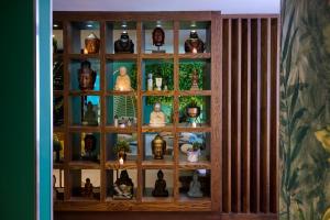 a wooden shelf with vases and plants in it at Malmaison Aberdeen in Aberdeen