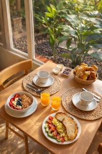 a wooden table with plates of food on it at Hotel Ideal in Miramar