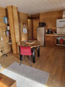 a kitchen with a table and a refrigerator at Eco-Logis des Cabris in Font-Romeu