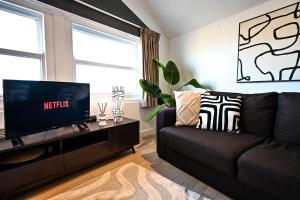 a living room with a couch and a flat screen tv at Starr Place in Liverpool