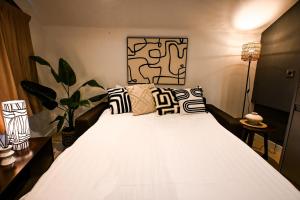 a bedroom with a white bed with pillows at Starr Place in Liverpool
