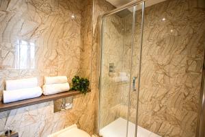 a bathroom with a shower and a toilet and towels at Starr Place in Liverpool
