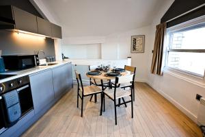 a kitchen with a table and chairs in a room at Starr Place in Liverpool