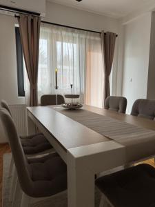 a white dining room table with chairs around it at Apartman Petrovic in Vranje