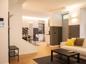 a living room with a couch and a table at Foresteria Dambro rooms -2 Min walk to Bernina Express in Tirano