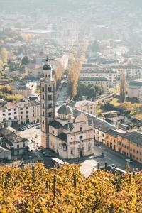 a view of a city with a clock tower at Foresteria Dambro rooms -2 Min walk to Bernina Express in Tirano