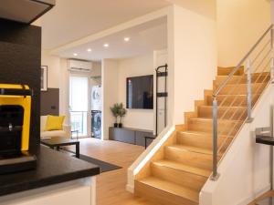 a living room with a staircase in a house at Foresteria Dambro rooms -2 Min walk to Bernina Express in Tirano