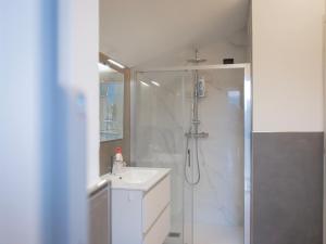 a white bathroom with a shower and a sink at Foresteria Dambro rooms -2 Min walk to Bernina Express in Tirano +20 photos