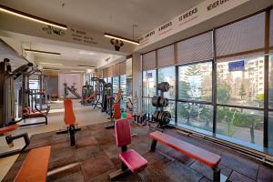 a gym with treadmills and exercise equipment in a building at VRR Astoria Hotel & Convention Center in Bangalore