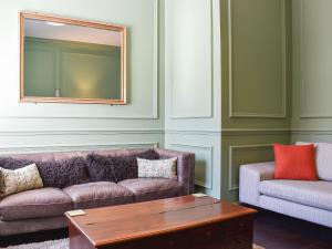 a living room with a couch and a coffee table at Scarborough Esplanade in Scarborough