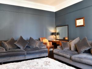 a living room with two couches and a mirror at Scarborough Esplanade in Scarborough