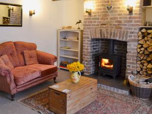 a living room with a couch and a fireplace at The Cottage in Broadstairs +10 photos