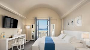 a hotel room with a bed and a window at Acroterra Rosa Luxury Suites & Spa in Akrotiri +84 photos