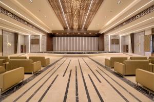 an image of a banquet hall with chairs and a stage at VRR Astoria Hotel & Convention Center in Bangalore +138 photos