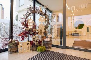 a store front window with a wreath and pumpkins at Hotel Park Superior 3* in Čakovec