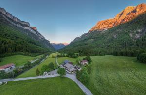 an aerial view of a house in the mountains at Strubwirt in Waidring