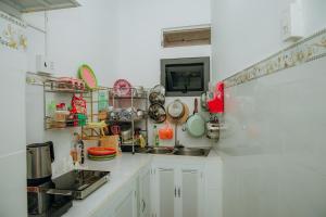 a kitchen with white cabinets and a sink at Thiện Homestay Dốc Lết -Gần Biển & Nguyên Căn in Ba Ha +34 photos