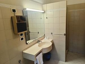 a bathroom with a sink and a mirror at Affittacamere San Cristoforo Faenza in Faenza