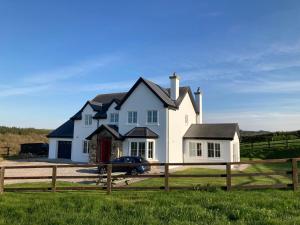 a house with a car parked in front of it at Hunthill in Tulach an Iarainn +2 photos