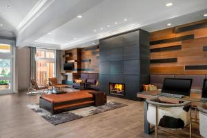 a living room with a fireplace and a laptop at Marin Hilltop Hotel in San Rafael