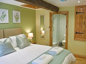 a bedroom with a large bed with towels on it at 14 Doomgate House - Uk45055 in Appleby