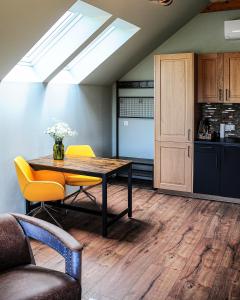 a dining room with a table and chairs and a kitchen at Janowe Wzgórze in Cieszyna +107 photos