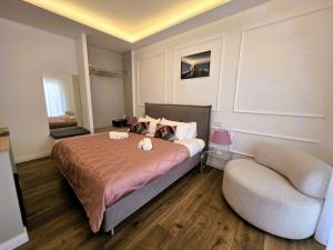 a bedroom with a bed and a chair at Riviera Suites - by Be Your Home in Civitavecchia