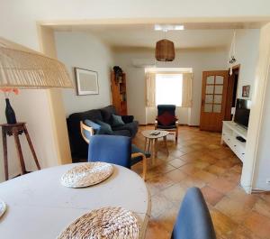 a living room with a couch and a table at Markádia in Alvito