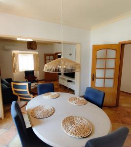 a dining room table with chairs and a room with a tableablish at Markádia in Alvito