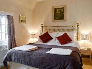 a bedroom with a large bed with two pillows at Hawthorn in Llanddona