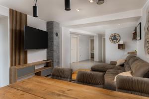 a living room with a couch and a table at House Cerovac in Nedeščina