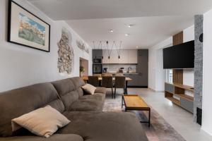 a living room with a couch and a dining room at House Cerovac in Nedeščina