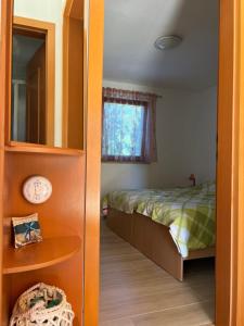 a small bedroom with a bed and a window at Apartment House Liznjan in Ližnjan