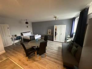 a living room with a table and a bed at Abbey Apartments in Dublin